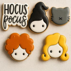 May include: A collection of Halloween-themed cookies. The cookies include the phrase "Hocus Pocus", a black-haired witch, a gray cat, and two other witch-themed cookies with orange and yellow hair. All cookies are decorated with white icing.