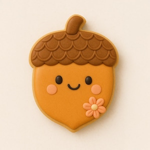 May include: A decorated acorn-shaped cookie with a smiling face, rosy cheeks, and a small flower. The cookie features a brown top with a textured pattern and a light orange body. The background is a solid, neutral color.