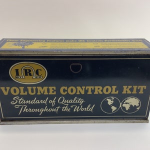 May include: A blue metal box with a gold label that reads "IRC VOLUME CONTROL KIT Standard of Quality Throughout the World". The box has a gold handle and two gold globes on the front.