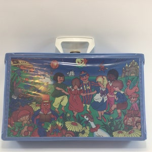 May include: A blue plastic carrying case with a white handle. The case has a colorful illustration of children playing in a field with a castle, a ship, and a sun in the background.
