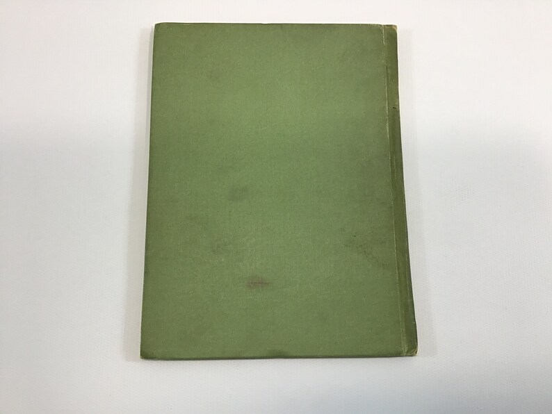 May include: A green book cover with a smooth, textured surface.