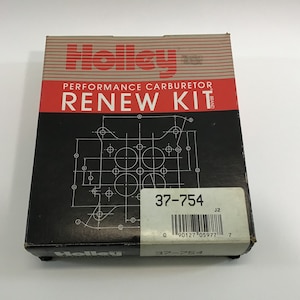 May include: A black and white box with the text "Holley Performance Carburetor Renew Kit" and a diagram of a carburetor. The box also has a white label with the text "37-754" and a barcode.