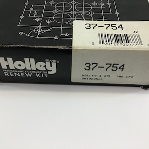 May include: A black and white box with the Holley brand logo and the text "Performance Carburetor Renew Kit" and the part number "37-754". The box also includes the text "Holley 4 BBL Universal 788 CFH".