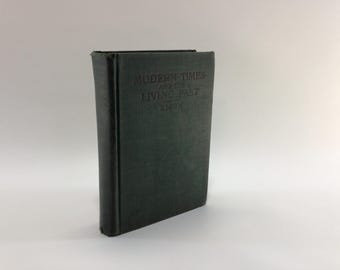 May include: A dark green hardcover book with the title "MODERN TIMES AND THE LIVING PAST" embossed on the front cover.