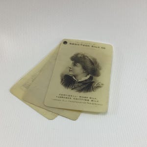 May include: A vintage card with a black and white image of a woman wearing a hat. The card reads "Conickal Wash Silk Florence Knitting Silk.  Licensed for manufacture by H.R. & Sons."
