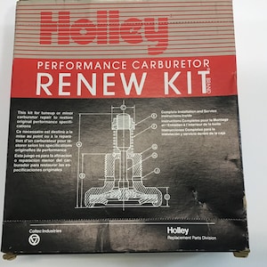 May include: A black and white box with the text "Holley PERFORMANCE CARBURETOR RENEW KIT" in red. The box contains a carburetor rebuild kit for restoring original performance specifications. The box also includes complete installation and service instructions.