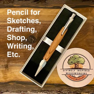 May include: A mechanical pencil with a light brown wood grain barrel and silver metal accents, presented in a rectangular box with a black interior. The text reads: Pencil for Sketches, Drafting, Shop, Writing, Etc. A circular logo is visible nearby.