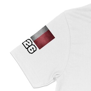 White t-shirt sleeve with a rectangular flag and the number 26.
