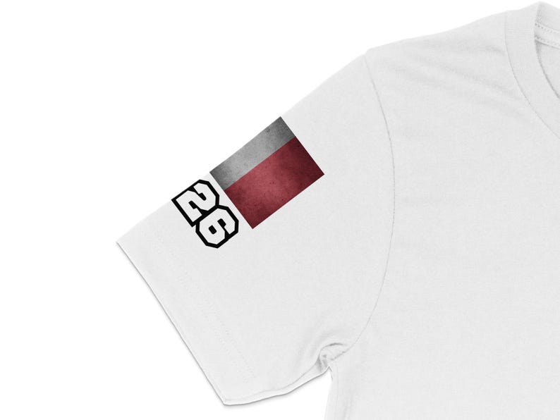White t-shirt sleeve with a rectangular flag and the number 26.