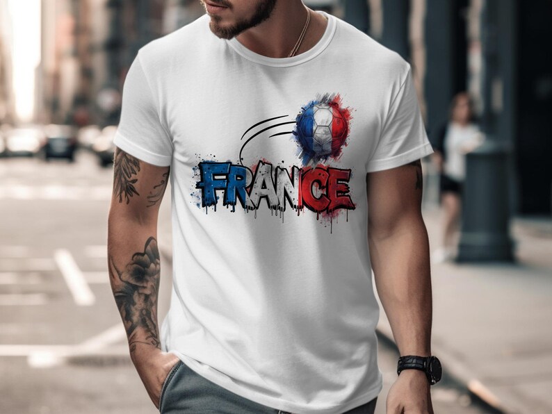 White t-shirt with "FRANCE" text in red, white, and blue watercolor, featuring a soccer ball.