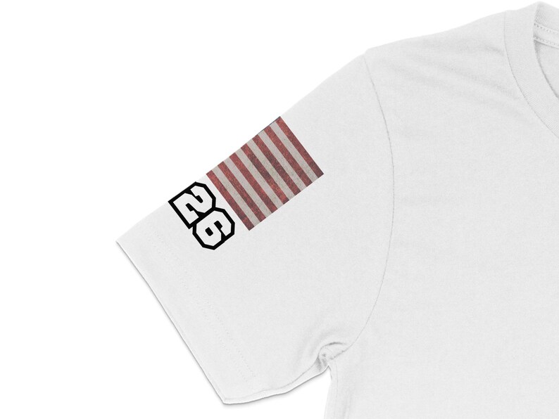 White t-shirt with "26" and American flag design on sleeve.