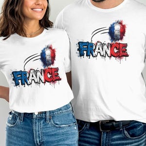 Two white t-shirts with "FRANCE" in red, white, and blue, and a soccer ball.