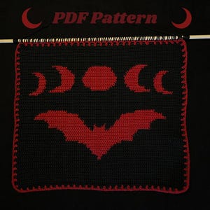 May include: Black and red crochet wall hanging with a bat and moon phases design. The text "PDF Pattern" is at the top. It has a red border and hangs from a wooden dowel. A craft item.