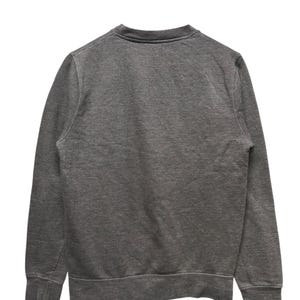 May include: A charcoal gray sweatshirt with a crew neck and ribbed cuffs and hem. The back view of the garment shows a simple, classic design, suitable for casual wear. The fabric appears to be a soft, knit material.
