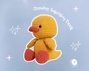 May include: A handmade, jumbo-sized, squishy duck plushie in yellow with a red beak and feet. The text "Jumbo Squishy Duck" is written in white cursive. The background is light blue with white star accents.