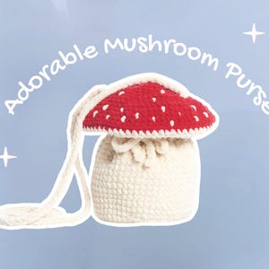 May include: A cream-coloured, crocheted mushroom-shaped purse with a red cap dotted with white spots. The purse has a long strap and the words "Adorable mushroom Purse" are written above the purse.