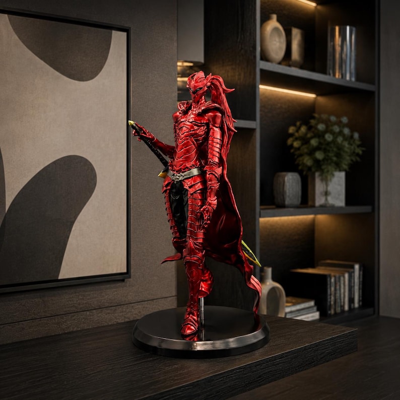 May include: A standing figurine of a warrior clad in metallic red armor with a long ponytail, wearing a silver belt, and holding a long sword. The figure is mounted on a circular black base, showcasing intricate plate armor details and a cape.