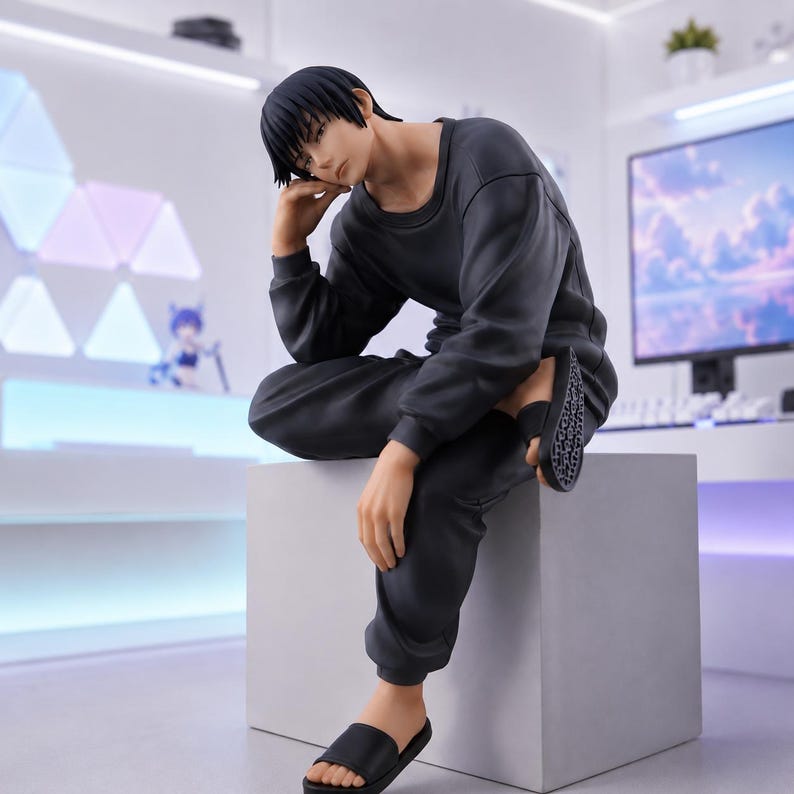May include: A collectible anime-style figure of a character with short black hair, wearing a long-sleeved dark gray sweatshirt and matching sweatpants. The figure is seated on a light gray cube, wearing black slide sandals on their feet.