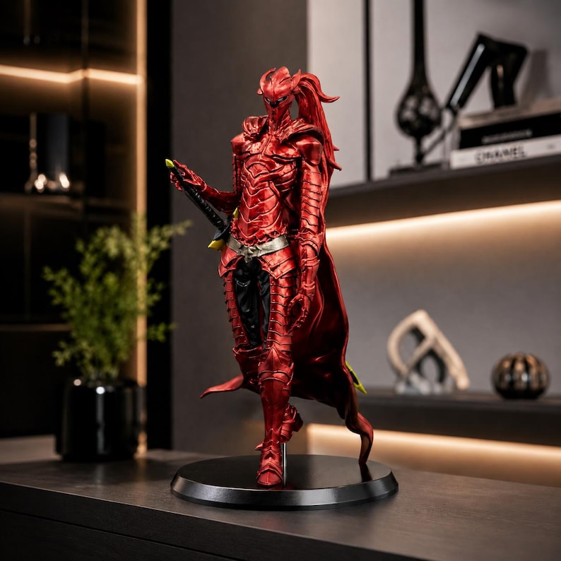 May include: A standing figurine of a warrior clad in metallic red segmented armor with a high collar, a flowing cape, and a silver belt. The figure holds a black sword at its side and features a pointed helmet with long, flowing red hair elements.
