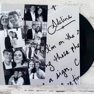 May include: A black vinyl record next to a sleeve featuring black and white photos of couples. The sleeve has handwritten text and the name "Adeline" in cursive. The photos are arranged in a collage.