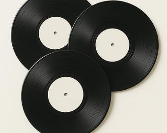 May include: Three black vinyl records with blank white labels are arranged in a fan shape. The records have a glossy finish and visible grooves. The white labels are circular with a small hole in the center. The records are a classic music medium.