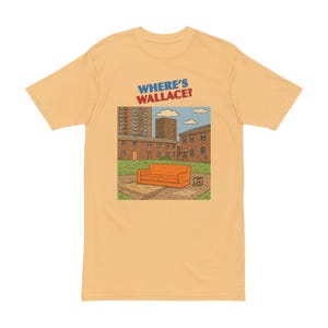 May include: A pale orange t-shirt with a cartoon graphic of a city scene, including a bright orange sofa. The text "WHERE'S WALLACE?" is printed above the illustration in blue and red.