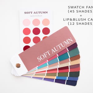 May include: A color palette swatch fan and lip & blush card for the Soft Autumn season. The fan displays 45 shades, while the card shows 12 shades. The fan is fanned out, revealing a range of colors, including pinks, reds, greens, and blues. The text "SOFT AUTUMN" is visible.