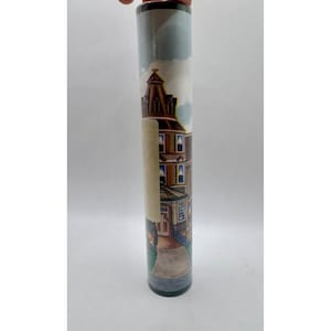 May include: Rolled wallpaper featuring a detailed illustration of a Victorian-style house with a brown exterior, multiple windows, and a prominent tower. The scene includes a pathway and a cloudy sky.
