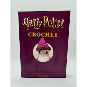 May include: A hardcover book titled "Harry Potter Crochet" in gold lettering on a deep purple background. The cover features a crocheted wizard with a pink hat and white beard. The author's name, Lucy Collin, is at the bottom.