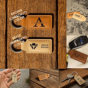 May include: Leather keychains in brown and beige with personalized text and designs. One keychain has the letter "A" and the name "Alex Jameson". Another has a cowboy hat and guns with the name "Bruce Wayne".