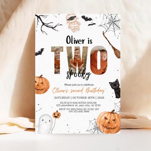 May include: A Halloween-themed birthday invitation card featuring the text Oliver is TWO SPOOKY, with photos of a child inside the letters. Illustrations include a mummy, bats, spiderwebs, a broom, a black cat, pumpkins, and a ghost.
