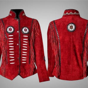 May include: Red suede jacket with fringe and decorative beadwork. The jacket features a high collar, long sleeves, and a button-up front. The design includes white and black accents, with decorative circles on the front and back.