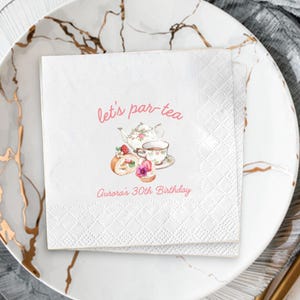 May include: White paper napkins with a diamond pattern, featuring a watercolor illustration of a teapot, teacup, and pastries. The text "let's par-tea" and "Aurora's 30th Birthday" are in pink script.