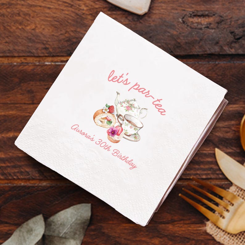 May include: White paper napkins with a pink border. The napkins feature the text "let's par-tea" and "Aurora's 30th Birthday" in pink script. A watercolor illustration of a teapot, teacup, and pastries is also present.
