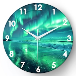 May include: Circular wall clock displaying a scenic image of the Aurora Borealis over a beach. The clock face has a teal and green colour scheme with white numerals and hands. A decorative item for any room.