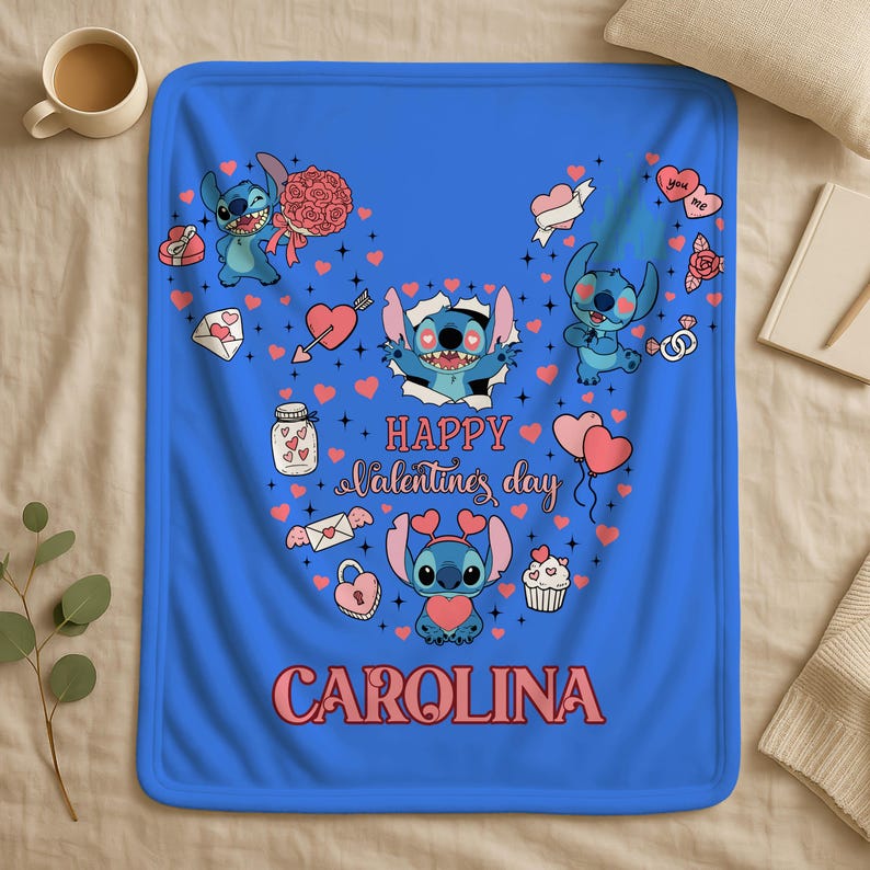 A blue blanket with a Valentine's Day theme, featuring illustrations of characters from the Lilo & Stitch animated series. The blanket has a personalized name, "Carolina", printed on it.