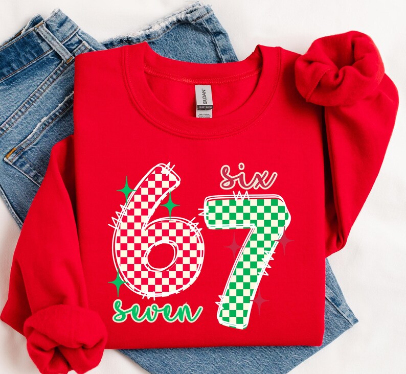 A red sweatshirt with the number "67" printed on it, along with the text "Six seven" in green and white.