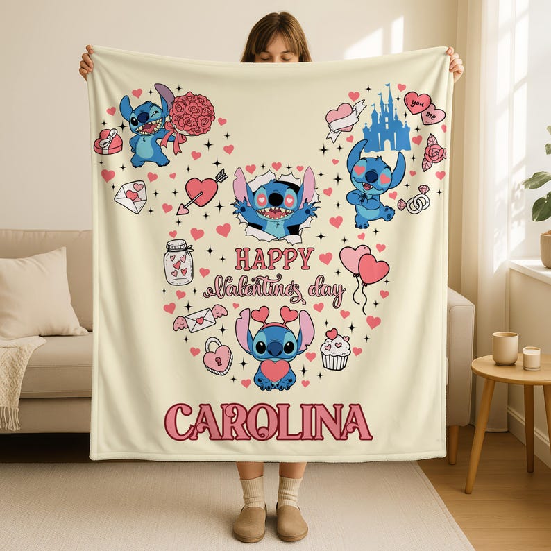 A person holding up a blanket with a Valentine's Day design featuring characters from the Disney movie "Stitch".