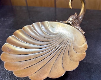 Cast brass shell-form trinket or soap dish with stylized fish handle, marked W.B. Mfg. Co.