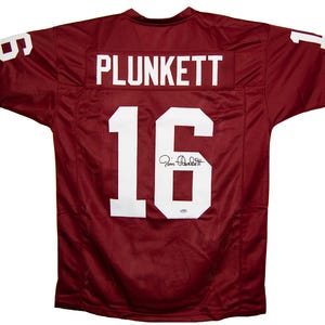 Maillot rouge cardinal dédicacé par Jim Plunkett