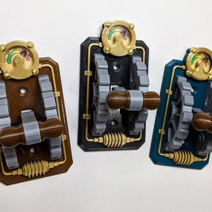 May include: Three 3D printed light switch covers with a steampunk design. Each cover features a gold-colored gear, a gold-colored knob, and a gold-colored gauge with a rainbow-colored needle. The covers are brown, black, and teal.