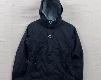 May include: Black hooded jacket with a light blue interior. The jacket features a full zipper, two front pockets, and two button closures. The hood is attached and has a drawstring. The jacket is made of a lightweight material.