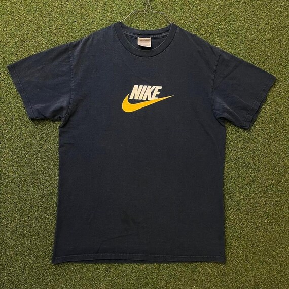 grey and yellow nike shirt