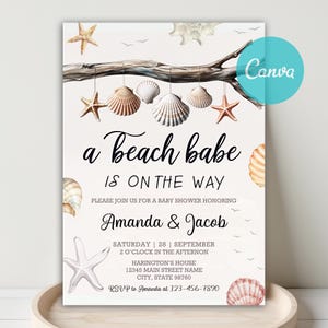 May include: A baby shower invitation with a beach theme. The invitation features seashells, starfish, and the text "a Beach babe IS ON THE WAY". The names Amanda & Jacob are also included. The invitation is decorated with a branch and small birds.