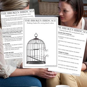 May include: Two women are seated, holding worksheets titled "The Broken Birdcage: Reclaiming freedom after surviving domestic violence." The worksheets feature a birdcage illustration and text about healing and freedom.