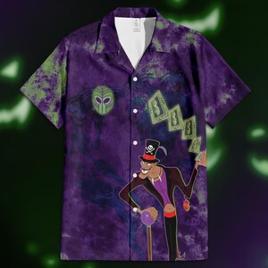 May include: Purple button-down shirt with a cartoon illustration of a character in a top hat and cane. The shirt has a tie-dye pattern with green and purple hues. The character is holding playing cards.
