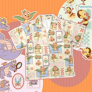 May include: A short-sleeved shirt featuring a repeating pattern of cartoon characters, including a purple dragon, orange birds, and bees. The shirt's background is a light cream colour with a grid of small squares. The overall theme is whimsical and playful.