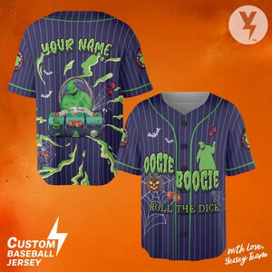 May include: Custom baseball jersey in navy blue with green pinstripes. The front features the text "Oogie Boogie Roll the Dice" with a jack-o'-lantern and spiderwebs. The back has "YOUR NAME" above a graphic of a character.