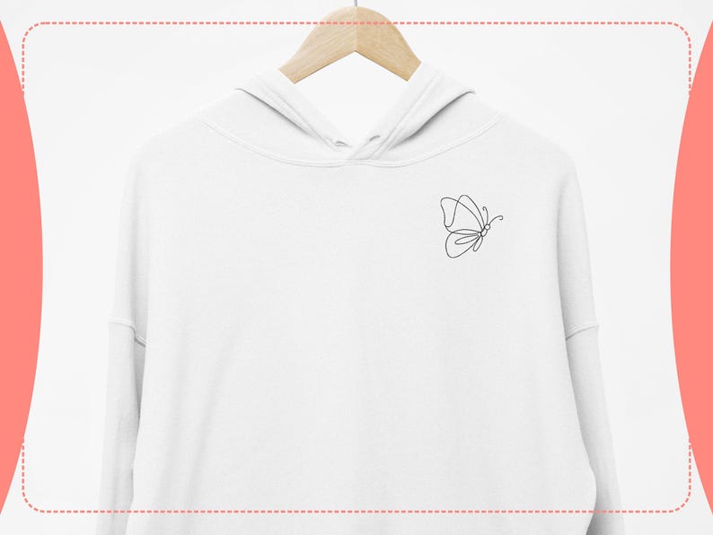 May include: White hoodie with a minimalist black butterfly outline design on the upper left chest. The hoodie is hanging on a wooden hanger against a white background. The butterfly design is a simple, continuous line.