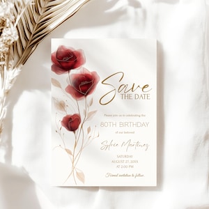 May include: A cream-colored invitation card with a floral design and gold script. The card features three red watercolor poppies and the words "Save the Date" in elegant calligraphy. The text also includes details for an 80th birthday celebration.